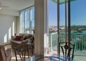 Thumbnail 17 of 18 - large windows and sliding glass doors leading to balcony