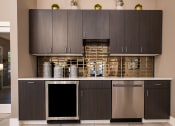 Thumbnail 15 of 26 - a kitchen with gray cabinets and stainless steel appliances