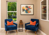 Thumbnail 16 of 26 - two blue chairs with orange pillows in a room with two windows