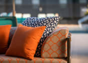 Thumbnail 5 of 26 - a couch with orange and blue pillows