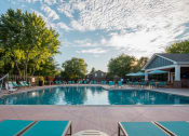 Thumbnail 1 of 26 - a swimming pool with lounge chairs and umbrellas