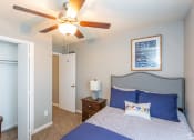 Thumbnail 23 of 26 - a bedroom with a bed and a ceiling fan