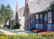 Thumbnail 24 of 26 - a row of houses with flowers in front of them