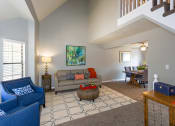 Thumbnail 20 of 26 - a living room with a staircase in the background and a dining room in the foreground