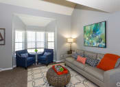 Thumbnail 21 of 26 - a living room with a couch and two chairs