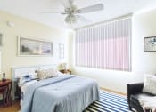 Thumbnail 9 of 17 - spacious bedroom with wood-style floor, large window, and ceiling fan