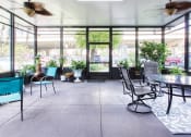 Thumbnail 14 of 17 - screened in patio with chairs, tables, ceiling fans, and plants