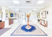 Thumbnail 2 of 17 - lobby with flower arrangement, reception desk, and mailboxes