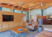 Thumbnail 8 of 24 - TV, couch, sitting area, and reception desk in lobby