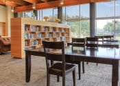 Thumbnail 12 of 24 - large book shelves with plenty of reading material and reading tables