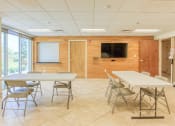 Thumbnail 20 of 24 - community room with tables and TV