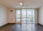 Thumbnail 17 of 24 - living room with ceiling fan, large windows, and door to balcony