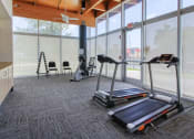 Thumbnail 23 of 24 - fitness center with cardio equipment and free weights 