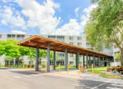 Thumbnail 2 of 24 - lushly landscaped covered walkway to St. Giles Manor