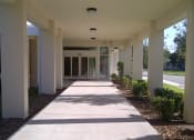 Thumbnail 2 of 12 - covered walkway with neat landscaping at St. Giles Manor II