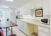 Thumbnail 5 of 12 - Community kitchen with microwave at St. Giles Manor