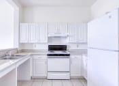 Thumbnail 6 of 12 - neat kitchen with efficient white appliances and white cabinetry