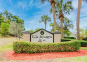 Thumbnail 2 of 15 - Monument signage with shrubs and palm trees