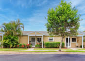 Thumbnail 6 of 15 - Beautiful villas with mature trees, neat sidewalks, and tropical flowers