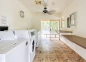 Thumbnail 15 of 15 - laundry room with washers, dryers, folding tables, and ceiling fan