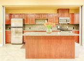 Thumbnail 9 of 15 - community kitchen with stainless steel appliances, island, and cabinets
