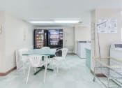 Thumbnail 22 of 23 - sitting area with drink and snack machines in laundry center