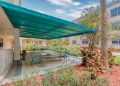 Thumbnail 9 of 23 - Covered patio with tables and chairs
