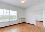 Thumbnail 18 of 23 - living room with large windows, overhead lighting and AC unit