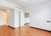 Thumbnail 17 of 23 - bedroom with hardwood-styled flooring and bathroom entrance