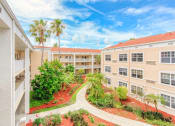Thumbnail 4 of 23 - Courtyard between residential buildings with lush landscaping