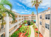 Thumbnail 3 of 23 - towering palms in courtyard between residential buildings