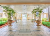 Thumbnail 8 of 23 - covered walkway with potted plants and benches