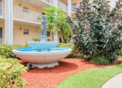 Thumbnail 5 of 23 - Beautiful sparkling fountain in lushly landscaped courtyard
