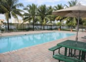 Thumbnail 4 of 24 - Crystal Lake Apartment's poolside picnic tables