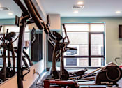 Thumbnail 46 of 82 - Beverly, MA Apartments- Holmes Beverly- Wall Mirror with Fully Equipped Gym and Large Windows