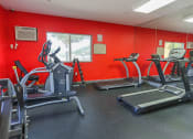 Thumbnail 12 of 13 - fully-equipped fitness center with cardio and strength equipment