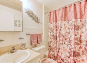Thumbnail 21 of 23 - bathroom with above sink lighting, mirror, flowered shower curtain