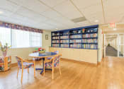 Thumbnail 12 of 23 - library with many books and reading tables and chairs