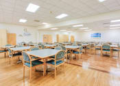 Thumbnail 16 of 23 - community room with many dining tables and chairs