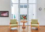 Thumbnail 6 of 16 - table and two chairs inside lobby area at Villa Regina