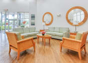 Thumbnail 5 of 16 - couches, chairs, and large mirrors in lobby by large windows and entrance