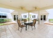 Thumbnail 15 of 16 - covered patio with ceiling fans and table and chairs