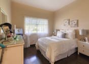 Thumbnail 13 of 16 - bedroom with hardwood-style floors, large windows, and model furniture