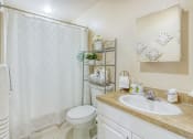 Thumbnail 14 of 16 - bathroom with large vanity, toilet, and shower-tub