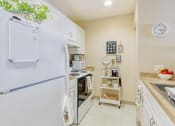 Thumbnail 10 of 16 - kitchen with white appliances and cabinets