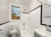 Thumbnail 14 of 15 - a bathroom with a toilet and a bath tub