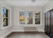 Thumbnail 5 of 15 - an empty room with four windows and a radiator
