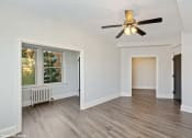Thumbnail 4 of 15 - a living room with hardwood floors and a ceiling fan