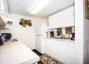 Thumbnail 5 of 12 - kitchen with white cabinets, appliances, and stainless steel double sink