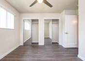 Thumbnail 10 of 17 - View from bedroom into sliding mirror door closet, has well lit window and ceiling fan